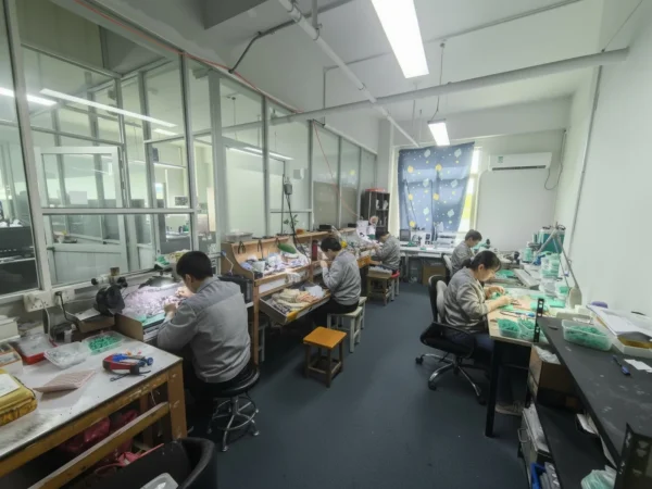 Jewelry artisans working at benches in the YueF workshop in Panyu, Guangzhou